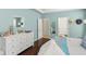 Spacious main bedroom with wood floors, white dresser and access to en-suite bathroom at 12824 Penshurst Ln, Windermere, FL 34786