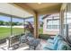 Covered patio with comfortable seating overlooking the backyard and neighborhood at 12824 Penshurst Ln, Windermere, FL 34786