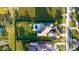 Aerial shot of a private home with a backyard pool, circular driveway, and manicured landscaping next to a lake at 13305 Bellaria Cir, Windermere, FL 34786