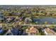 Aerial view of a luxury home on a large lot with lush landscaping, near a lake and other upscale residences at 13305 Bellaria Cir, Windermere, FL 34786