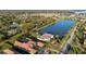 Luxury home on a lake with a fountain, surrounded by lush landscaping and well-maintained properties in an upscale neighborhood at 13305 Bellaria Cir, Windermere, FL 34786