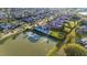 An aerial view features a backyard oasis with a pool and lake view in a beautiful neighborhood setting at 13305 Bellaria Cir, Windermere, FL 34786