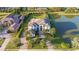 Expansive aerial view of luxury home with circular driveway, landscaping, and a private lake at 13305 Bellaria Cir, Windermere, FL 34786