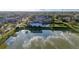 Panoramic view of a luxurious home with a spacious yard and a serene lake, perfect for outdoor enjoyment at 13305 Bellaria Cir, Windermere, FL 34786