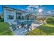 Luxury home backyard featuring a swimming pool, outdoor seating, and a meticulously maintained lawn on a sunny day at 13305 Bellaria Cir, Windermere, FL 34786
