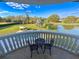 Balcony featuring wrought iron table and chairs overlooking lush green yard and pond at 13305 Bellaria Cir, Windermere, FL 34786