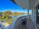 Balcony featuring wrought iron table and chairs overlooking pond and manicured lawn at 13305 Bellaria Cir, Windermere, FL 34786