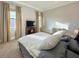 Cozy bedroom with plush bedding and a quaint writing desk illuminated by natural light at 13305 Bellaria Cir, Windermere, FL 34786