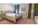 Cozy bedroom with an iron bed frame, soft lighting, and neutral tones creating a relaxing and inviting atmosphere at 13305 Bellaria Cir, Windermere, FL 34786