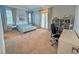 Bright bedroom featuring neutral walls and carpet, plus a desk and shelving unit at 13305 Bellaria Cir, Windermere, FL 34786