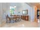 Formal dining room with elegant wood table and chairs, complemented by decorative molding and a large mirror at 13305 Bellaria Cir, Windermere, FL 34786