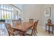 Cozy dining room featuring a wood table with travertine floors and large windows at 13305 Bellaria Cir, Windermere, FL 34786