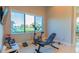 Bright exercise room featuring stationary bike, workout bench and scenic lake view at 13305 Bellaria Cir, Windermere, FL 34786