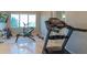 Home gym featuring an elliptical machine, treadmill, and lake views at 13305 Bellaria Cir, Windermere, FL 34786