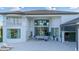 Elegant home with an expansive patio, showcasing stunning architectural details and lake view at 13305 Bellaria Cir, Windermere, FL 34786