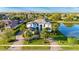 Beautifully landscaped luxury home with a circular driveway, tile roof and lush tropical foliage, located near a picturesque lake at 13305 Bellaria Cir, Windermere, FL 34786