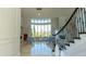 Grand foyer with soaring ceilings, curved staircase, and large windows, offering ample natural light at 13305 Bellaria Cir, Windermere, FL 34786