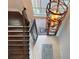 Grand foyer featuring a modern chandelier, tile flooring, and an inviting entrance at 13305 Bellaria Cir, Windermere, FL 34786