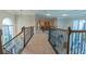 Upstairs hallway featuring carpet, ornate railings, natural light and art at 13305 Bellaria Cir, Windermere, FL 34786