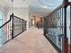 A wide hallway with decorative iron railings and views into other parts of the house at 13305 Bellaria Cir, Windermere, FL 34786