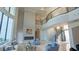 Bright living room featuring a fireplace, large windows, travertine floors, and staircase at 13305 Bellaria Cir, Windermere, FL 34786