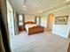 This is the home's main bedroom with neutral walls, a tray ceiling, and balcony access at 13305 Bellaria Cir, Windermere, FL 34786