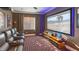 Home theater with plush seating, projector screen, and ambient lighting at 13305 Bellaria Cir, Windermere, FL 34786