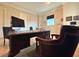 Office with large dark wood desk, black rolling chairs, and a window with a view at 13305 Bellaria Cir, Windermere, FL 34786