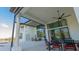 Outdoor kitchen and patio with ceiling fan, perfect for outdoor entertaining with backyard and water view at 13305 Bellaria Cir, Windermere, FL 34786