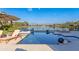 Resort-style pool overlooking a serene lake with fountain features and deck chairs at 13305 Bellaria Cir, Windermere, FL 34786