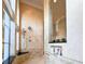 Luxurious walk-in shower featuring stone walls, bench seat, and window at 13305 Bellaria Cir, Windermere, FL 34786