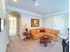 Comfortable sitting room with corner couch, wood tables and carpet at 13305 Bellaria Cir, Windermere, FL 34786