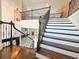 Elegant staircase with white risers, dark wood treads, and iron railings at 13305 Bellaria Cir, Windermere, FL 34786