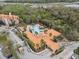 Overhead shot of community pool, clubhouse and surrounding area with palm trees at 1375 Tuscana Ln # 1406, Davenport, FL 33896