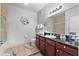 Elegant bathroom with a dark wood vanity and tile flooring, providing a luxurious feel at 1375 Tuscana Ln # 1406, Davenport, FL 33896