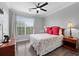 Comfortable bedroom with a large window, ceiling fan, and plush bedding at 1375 Tuscana Ln # 1406, Davenport, FL 33896
