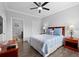 Cozy bedroom with wood floors, a ceiling fan, and warm, inviting decor at 1375 Tuscana Ln # 1406, Davenport, FL 33896