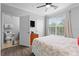 Sunlit bedroom with a ceiling fan, walk-in closet, and adjacent bathroom at 1375 Tuscana Ln # 1406, Davenport, FL 33896
