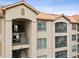 Condominium exterior featuring a beautiful facade, terracotta roof, and private balconies at 1375 Tuscana Ln # 1406, Davenport, FL 33896