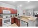 Well-lit kitchen with modern appliances, granite countertops, and tile flooring at 1375 Tuscana Ln # 1406, Davenport, FL 33896