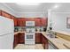 Contemporary kitchen featuring stainless appliances, granite counters, and wood cabinets at 1375 Tuscana Ln # 1406, Davenport, FL 33896