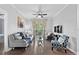 Cozy living room with a modern ceiling fan, wood floors, and a balcony with an outdoor view at 1375 Tuscana Ln # 1406, Davenport, FL 33896