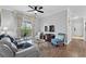 Bright living room featuring a ceiling fan, wood floors, and a sliding glass door to the balcony at 1375 Tuscana Ln # 1406, Davenport, FL 33896