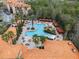 Aerial view of the community pool with cabanas and lounge chairs at 1375 Tuscana Ln # 1406, Davenport, FL 33896