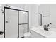 Modern bathroom with a glass-enclosed shower, white subway tile, and sleek black fixtures at 15543 Gentle Rain Dr # 197, Winter Garden, FL 34787