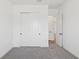 Bright bedroom features a closet, neutral carpeting, and crisp white trim at 15543 Gentle Rain Dr # 197, Winter Garden, FL 34787