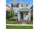 Charming two-story home with a blue front door, tidy landscaping, and freshly cut green grass at 15543 Gentle Rain Dr # 197, Winter Garden, FL 34787