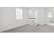 Hallway with neutral walls and carpet features staircase and adjacent bathroom at 15543 Gentle Rain Dr # 197, Winter Garden, FL 34787