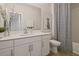 Bright bathroom with white cabinetry, modern fixtures, and stylish decor at 15567 Gentle Rain Dr # 194, Winter Garden, FL 34787