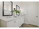 Elegant bathroom with dual sinks, modern mirrors, and a walk-in shower at 15567 Gentle Rain Dr # 194, Winter Garden, FL 34787